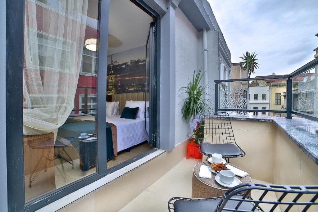 Private balcony of a room at The Tango Hotel Taksim with breakfast set over the rooftops of Beyoglu