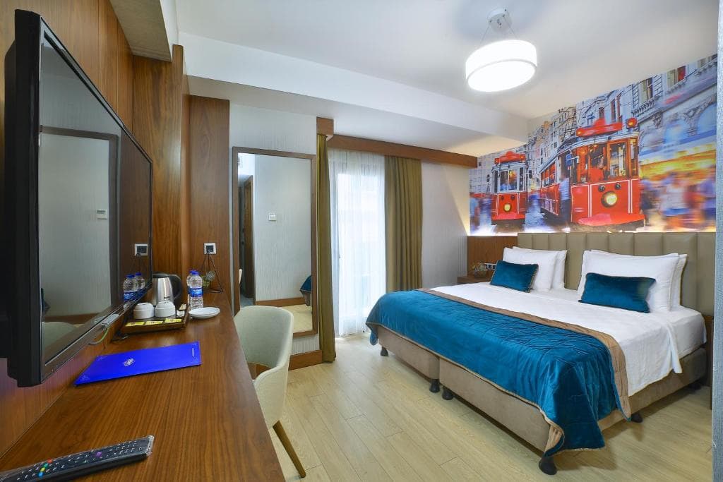 Soundproofed double room at The Tango Hotel Taksim with a nostalgic tram mural above the bed